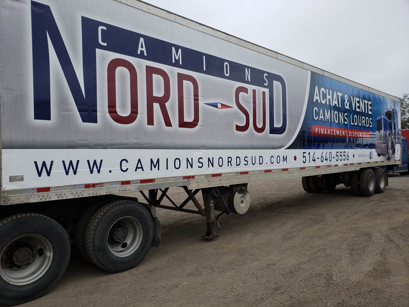 Lettered semi-trailer hitched to a tractor